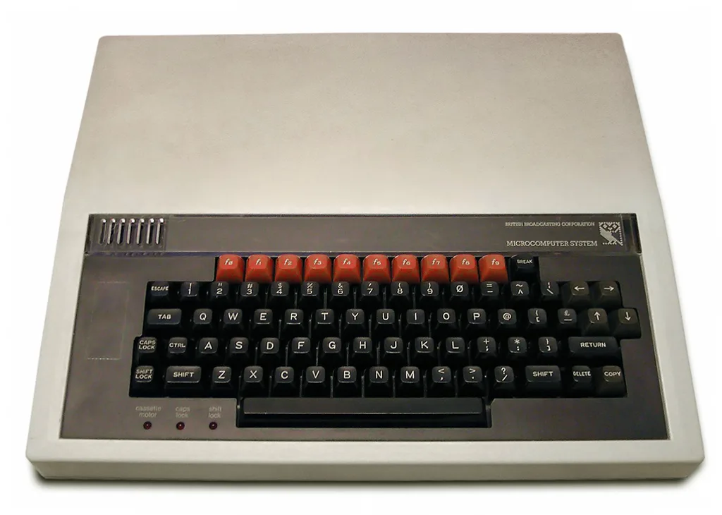 A BBC Micro computer seen from the front, with its black keyboard and a row of red function keys