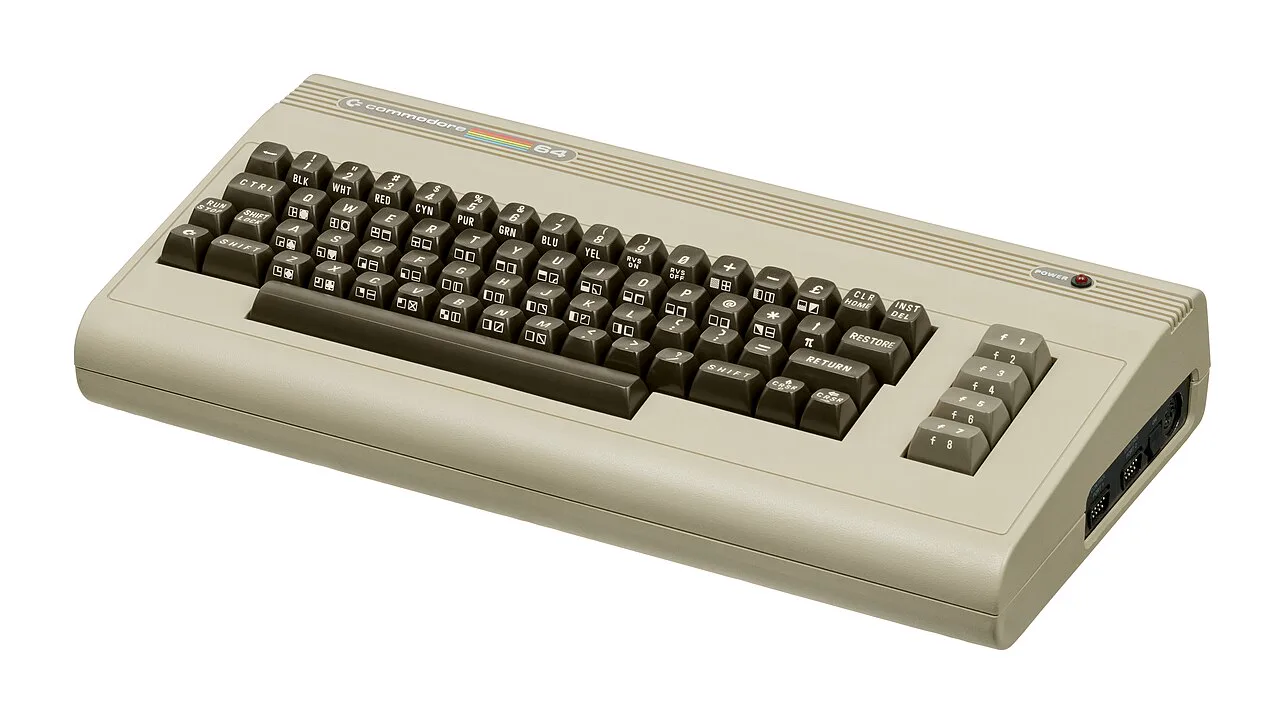 A beige Commodore 64 home computer with its brown keyboard, seen from the front left