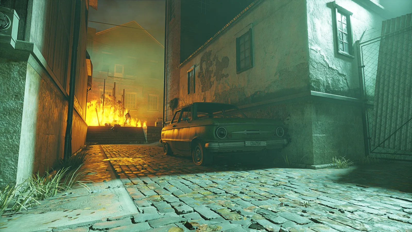 A parked car in a cobblestone alley with a fire burning at the far end, lit in green and orange