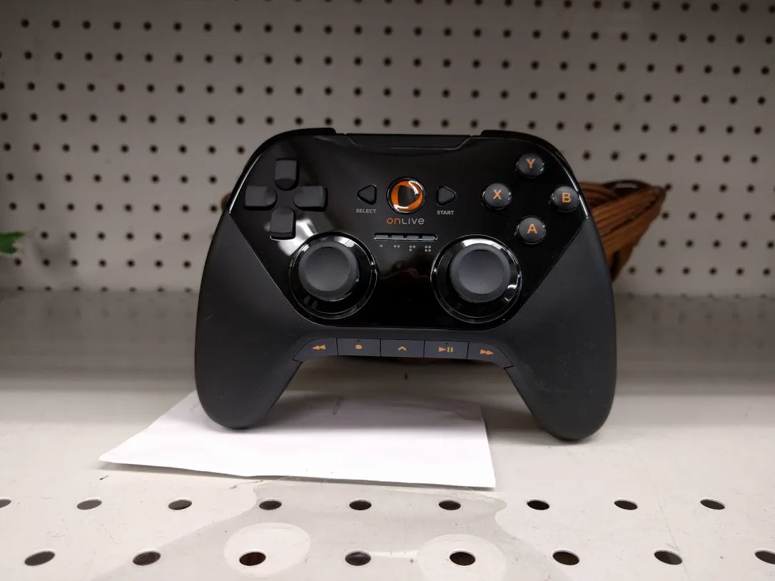 A black OnLive wireless controller with two analog sticks, a D-pad and A, B, X, Y buttons