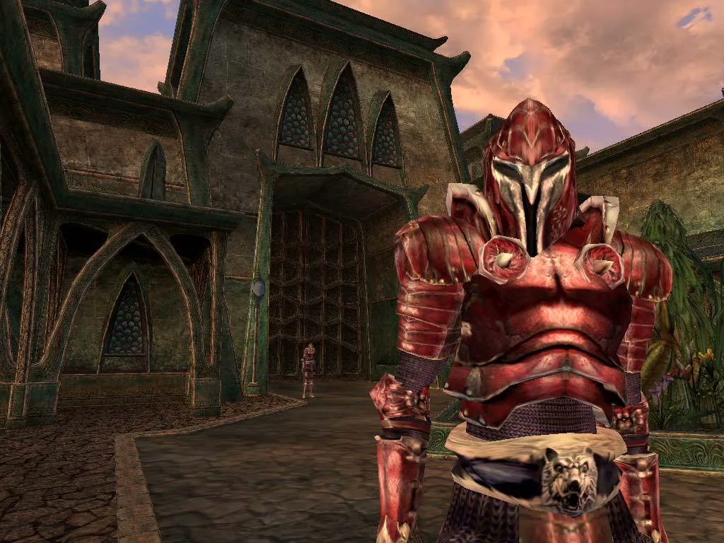A player character in red armor stands on a street in front of a green stone building in the original Morrowind