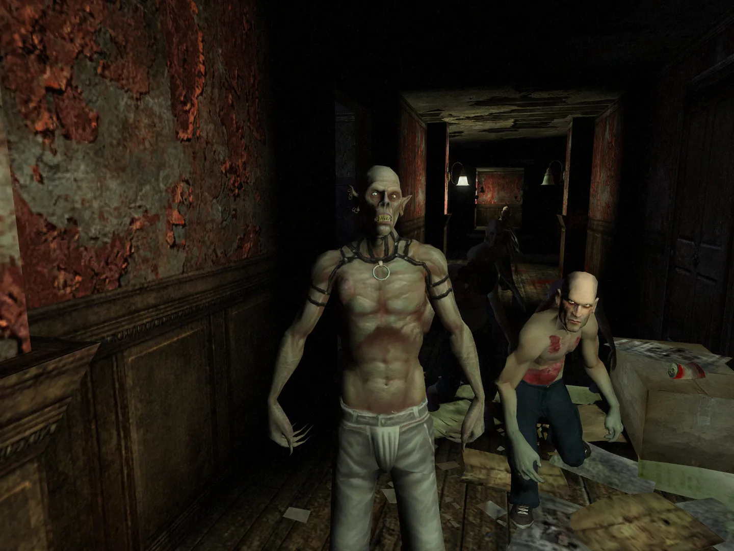Two gaunt, shirtless vampires with claws stand in a dim hallway with peeling red wallpaper.