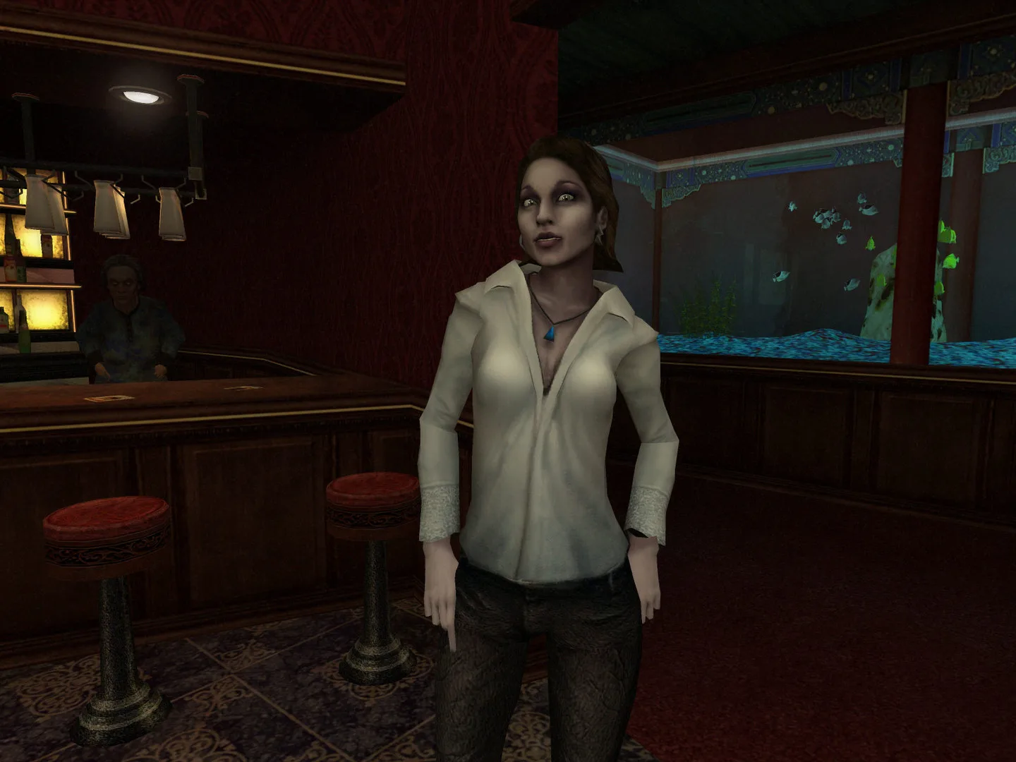 A pale vampire woman in a white blouse stands in a red-walled bar with an aquarium behind her.