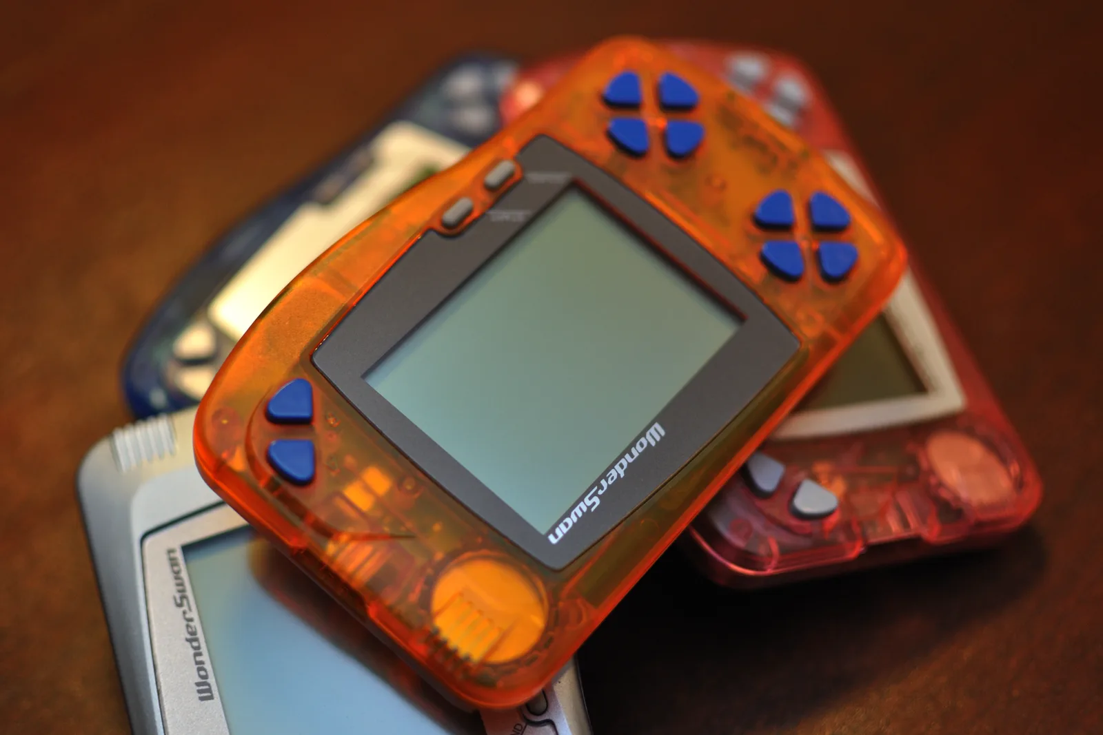 Several WonderSwan consoles in different colors lined up together